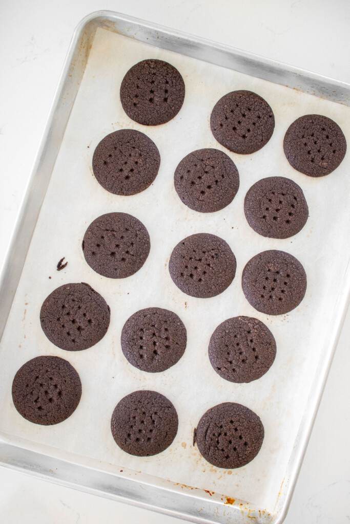 homemade peanut butter oreo cookies on a baking sheet on a marble counter.
