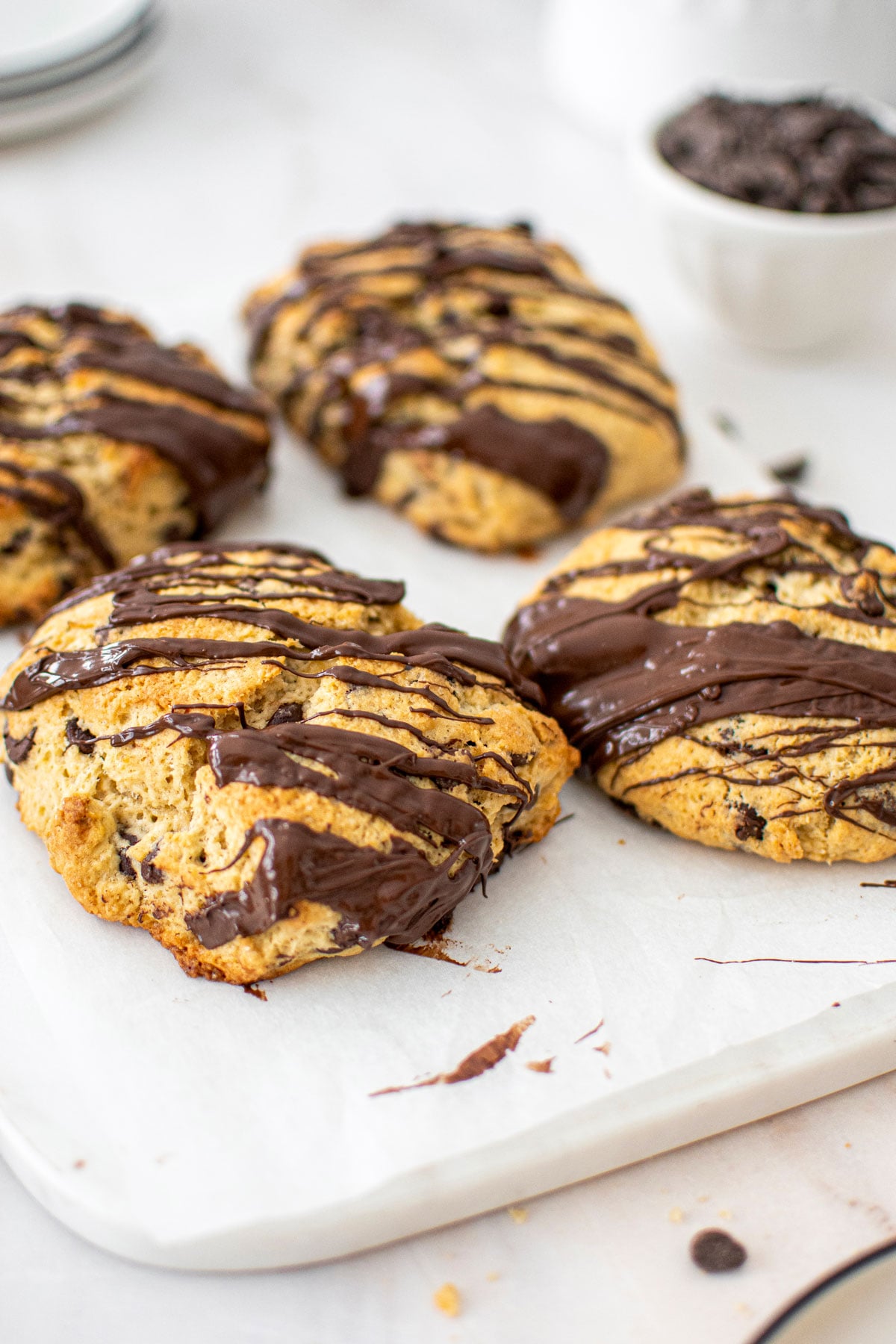 sourdough chocolate chip scones on a marble cutting board on a marble counter.