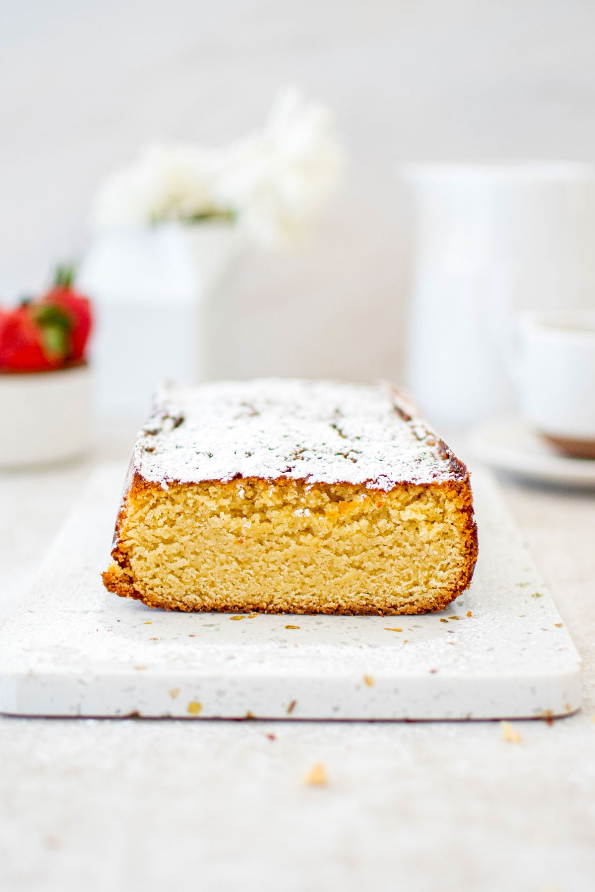 traditional butter pound cake loaf on a white marble board.