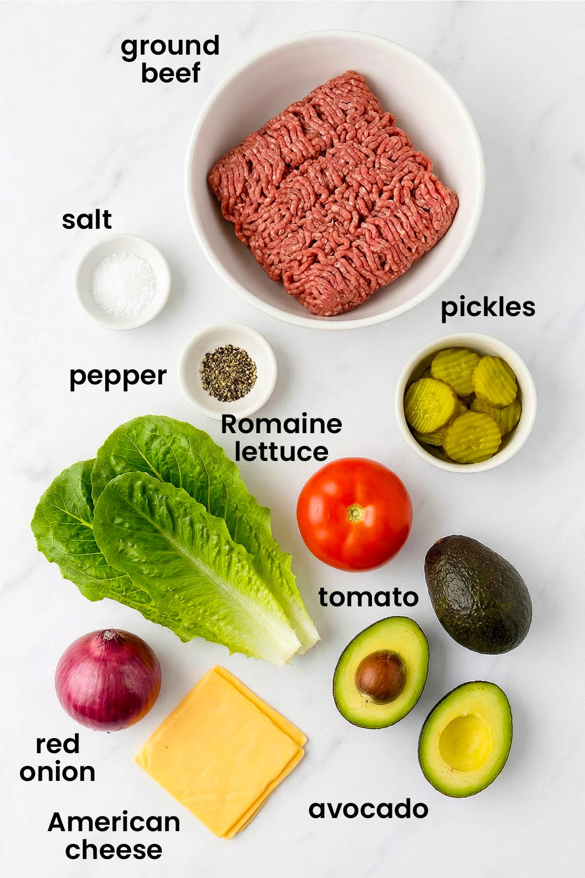 individual ingredients for avocado lettuce wrap burgers laid out against a white background.