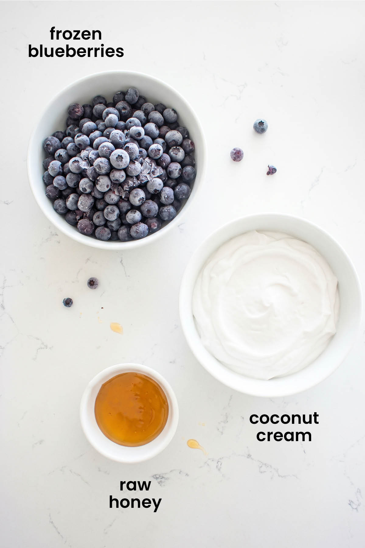 individual ingredients for homemade blueberry pup cups laid out against a white background.
