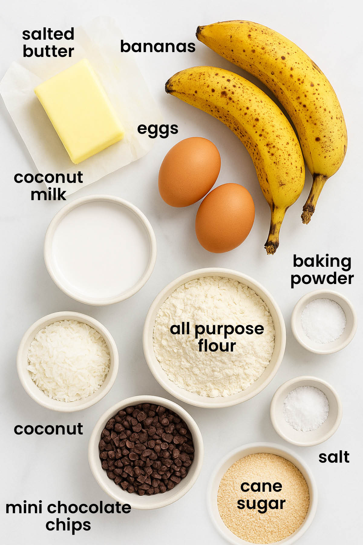 individual ingredients for coconut chocolate chip banana bread laid out against a white background.