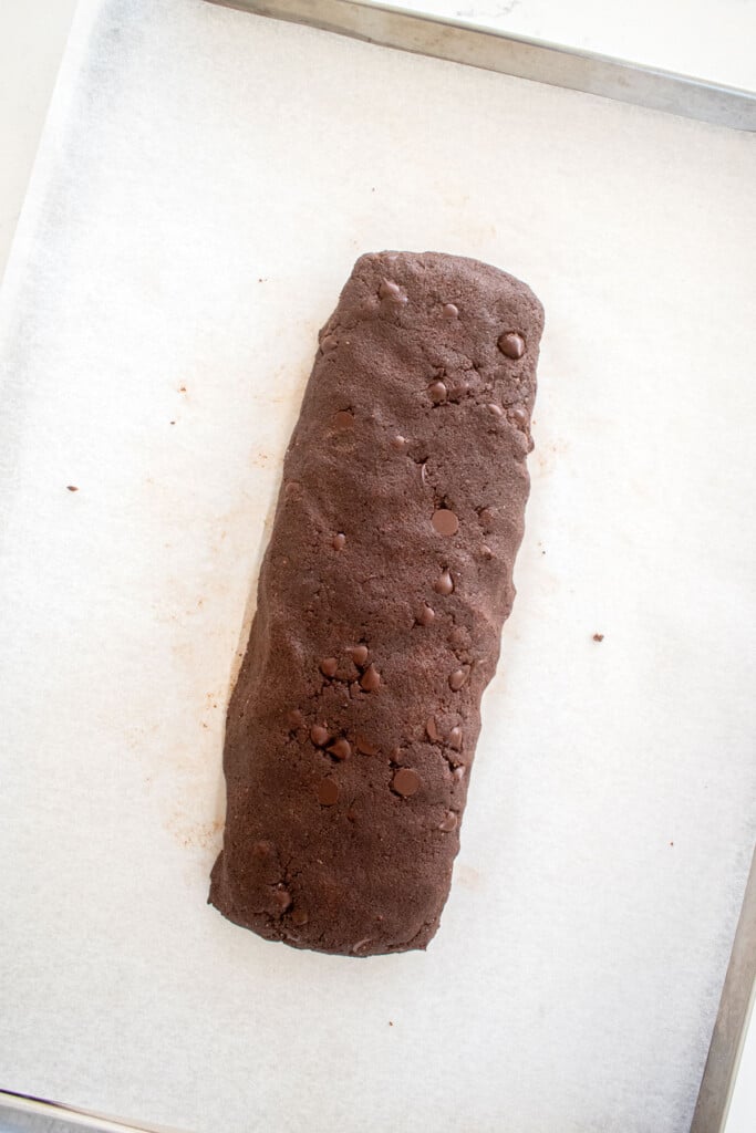 chocolate espresso biscotti cookie dough log on a baking sheet.