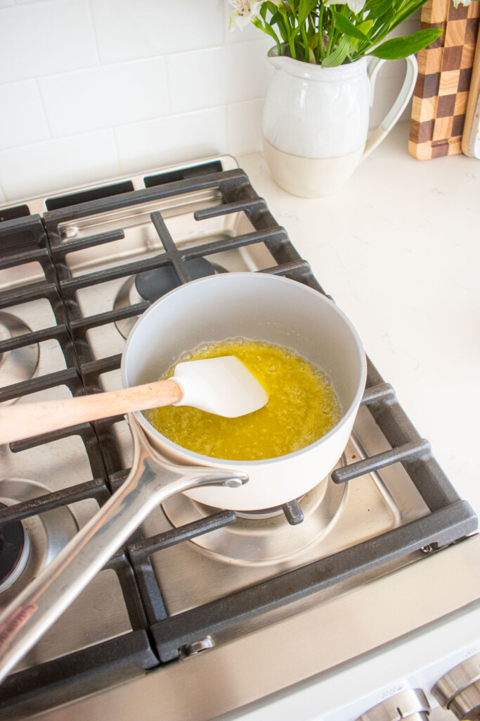 melted butter in a small saucepan on a stovetop.