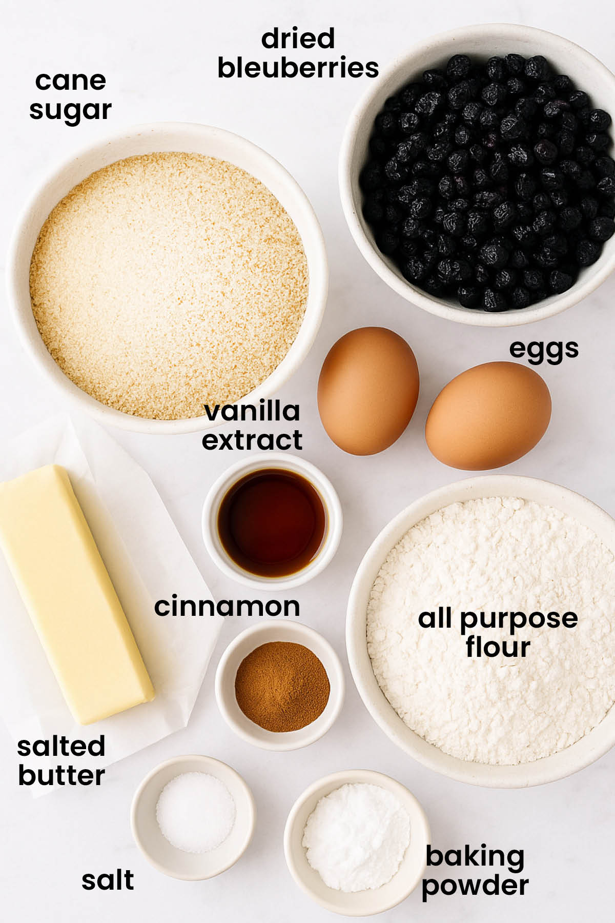 individual ingredients for blueberry muffin biscotti laid out against a white background.