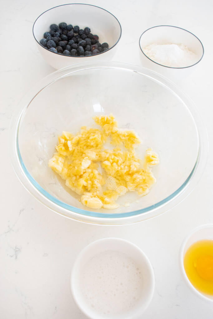 mashed up bananas in a mixing bowl on the counter.