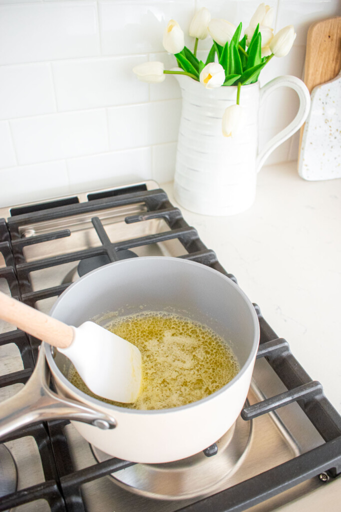 melted butter being stirred in a small pot over the stovetop.