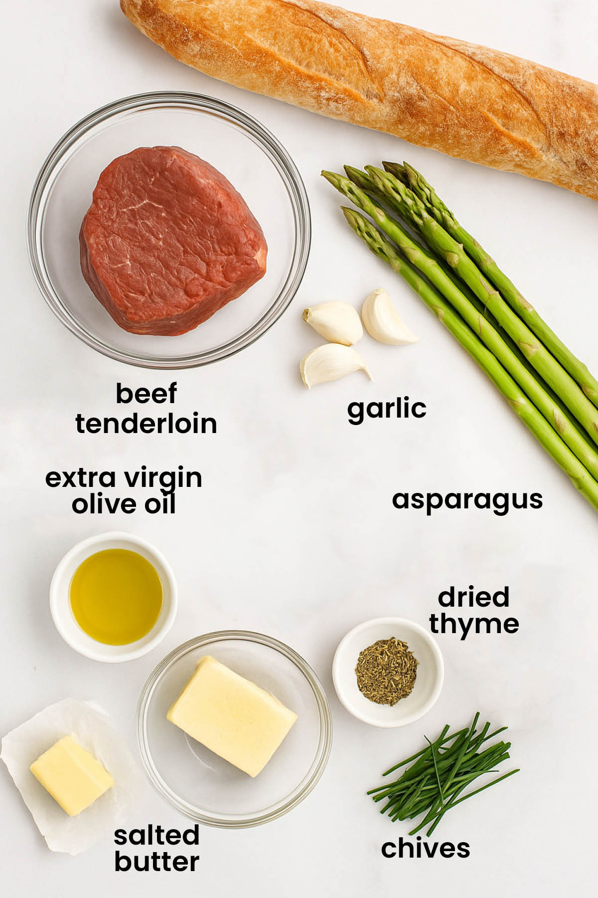 individual ingredients for garlic herb beef tenderloin steak laid out against a white background.