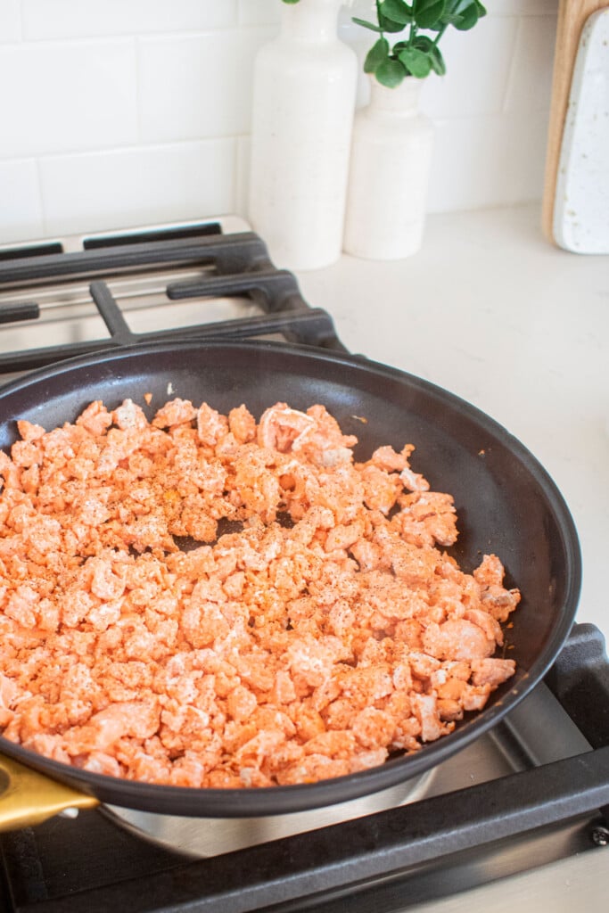 cooked ground salmon in a large skillet on the stovetop.
