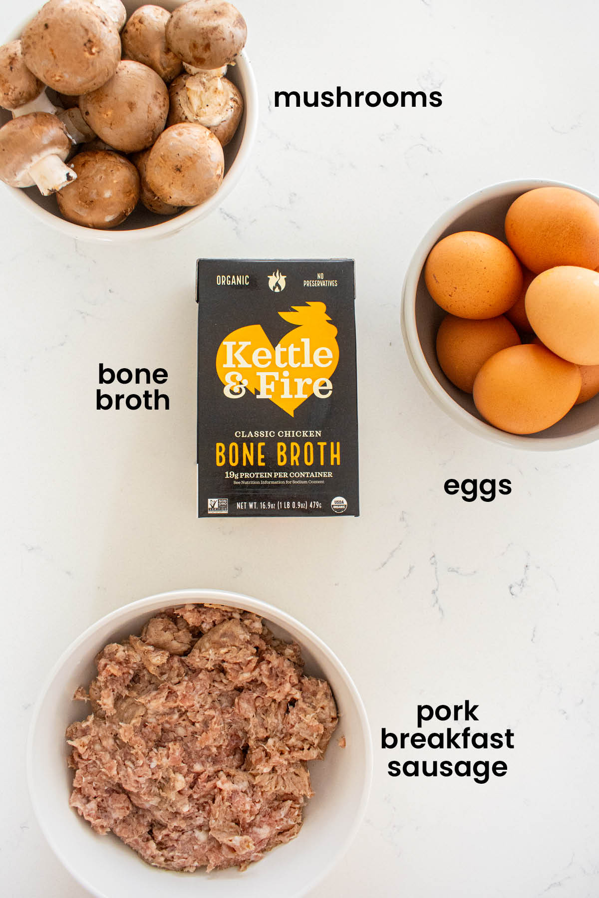 individual ingredients for bone broth sausage mushroom frittata laid out against a white background.
