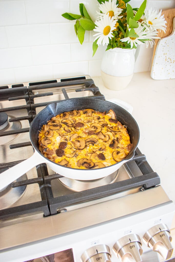 cooked bone broth sausage mushroom frittata cooling on the stovetop.