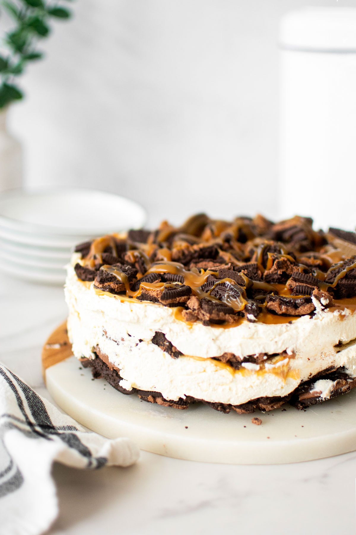 caramel chocolate oreo icebox cane on a white marble serving board.