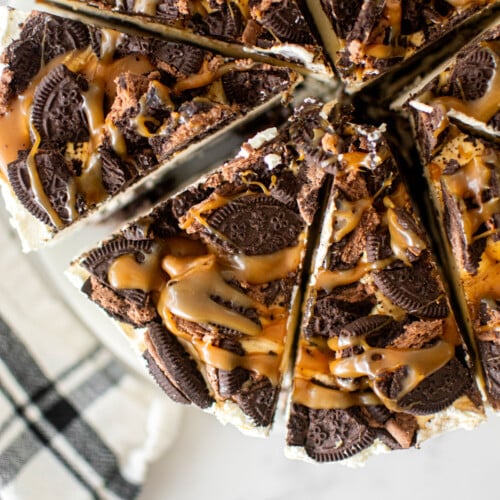caramel chocolate oreo icebox cane cut into slices on a white marble serving board.