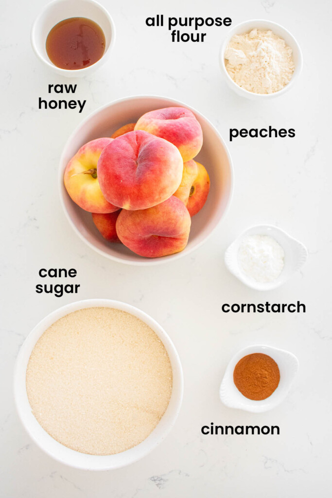 individual ingredients for sourdough peach galette laid out against a white background.