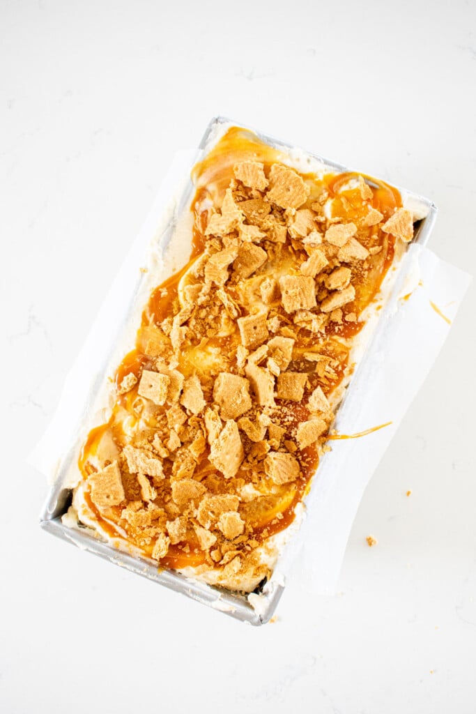 banoffee icebox cake in a loaf pan on a white marble counter.