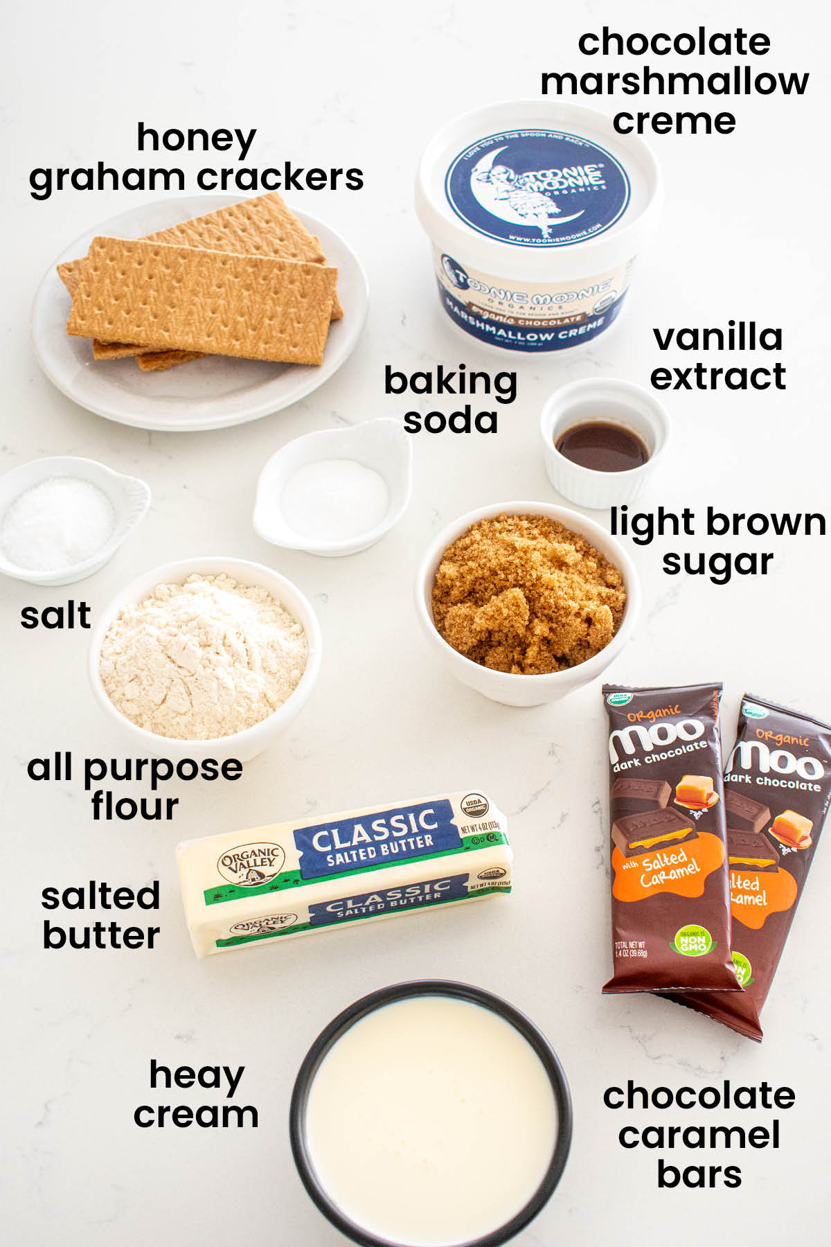 individual ingredients for chocolate caramel smore bars laid out against a white background.