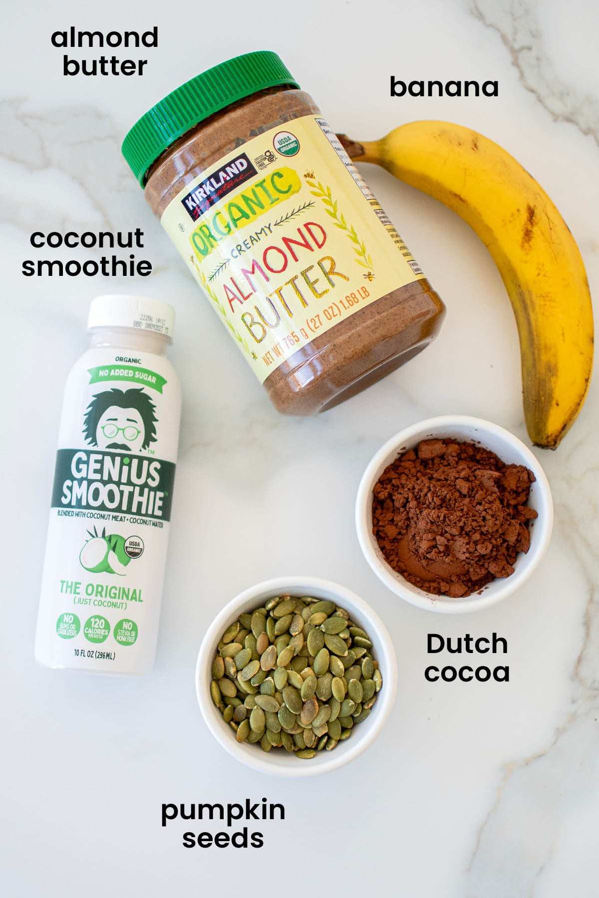 individual ingredients for chocolate smoothie with almond butter laid out against a white background.