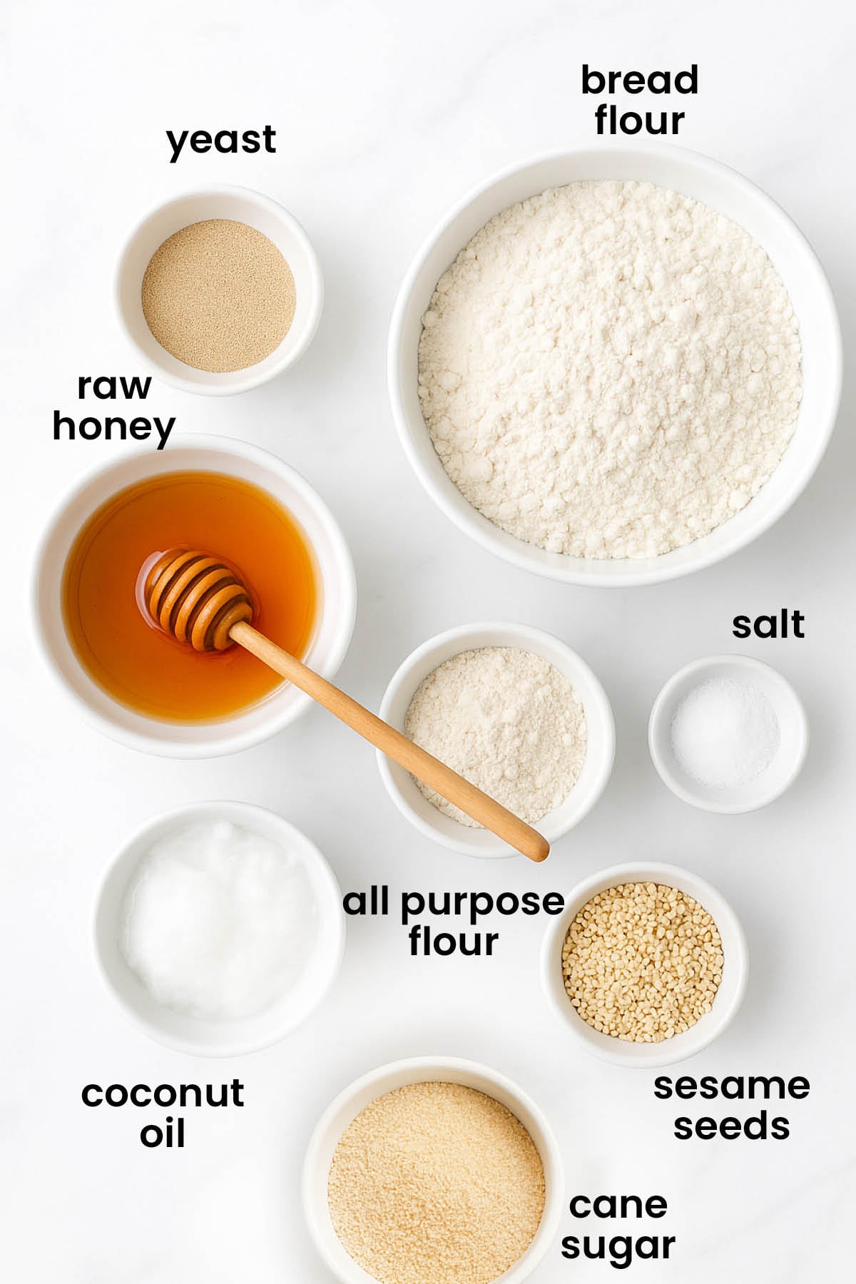 individual ingredients for homemade sesame bagels laid out against a white background.