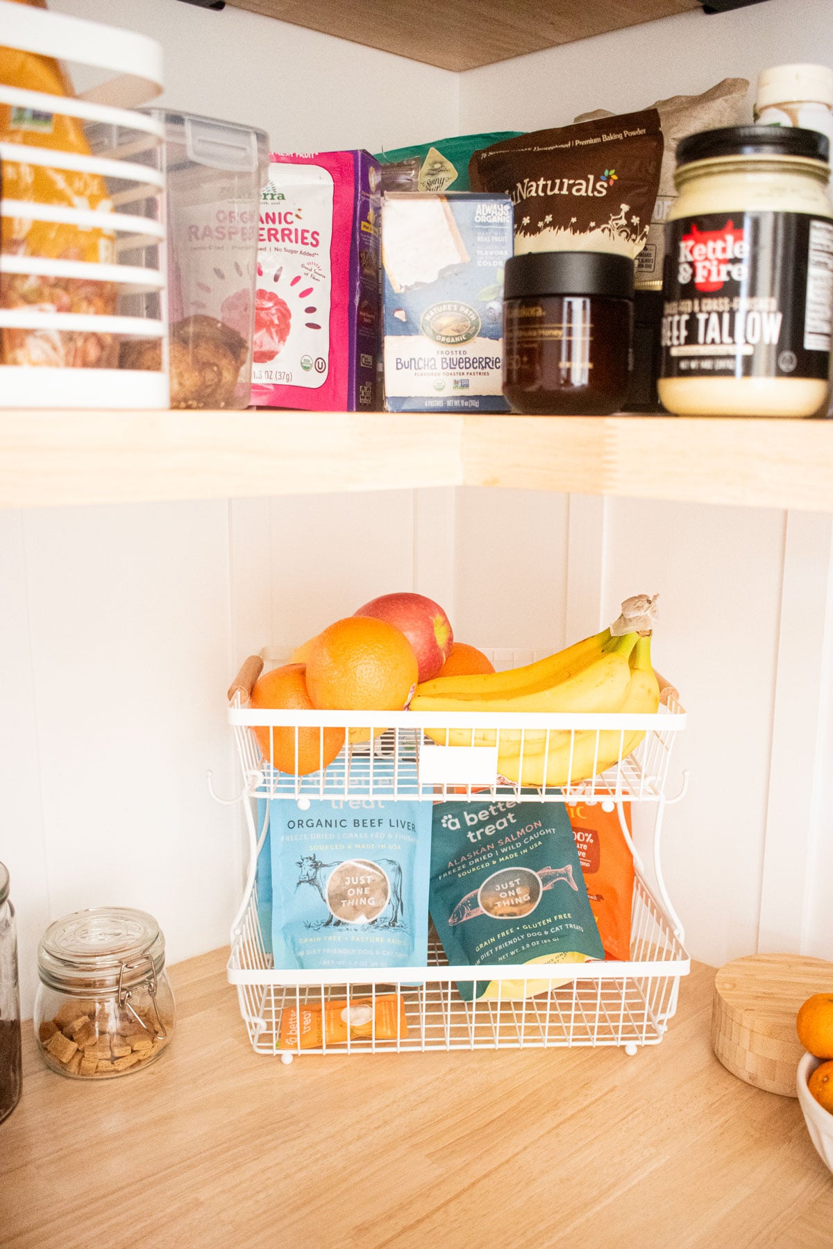 diy kitchen corner pantry with wood counters and pantry storage bins.