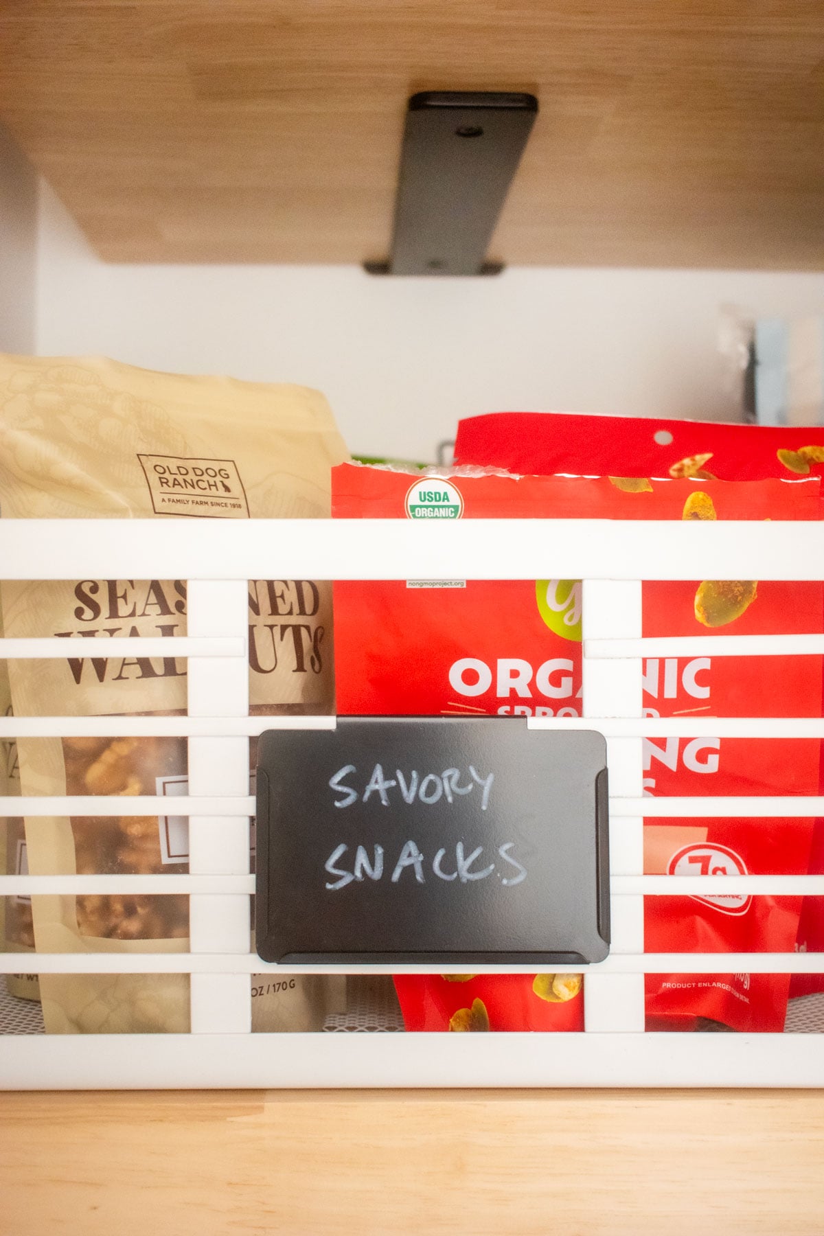 pantry storage bin on a wood pantry shelf with food.