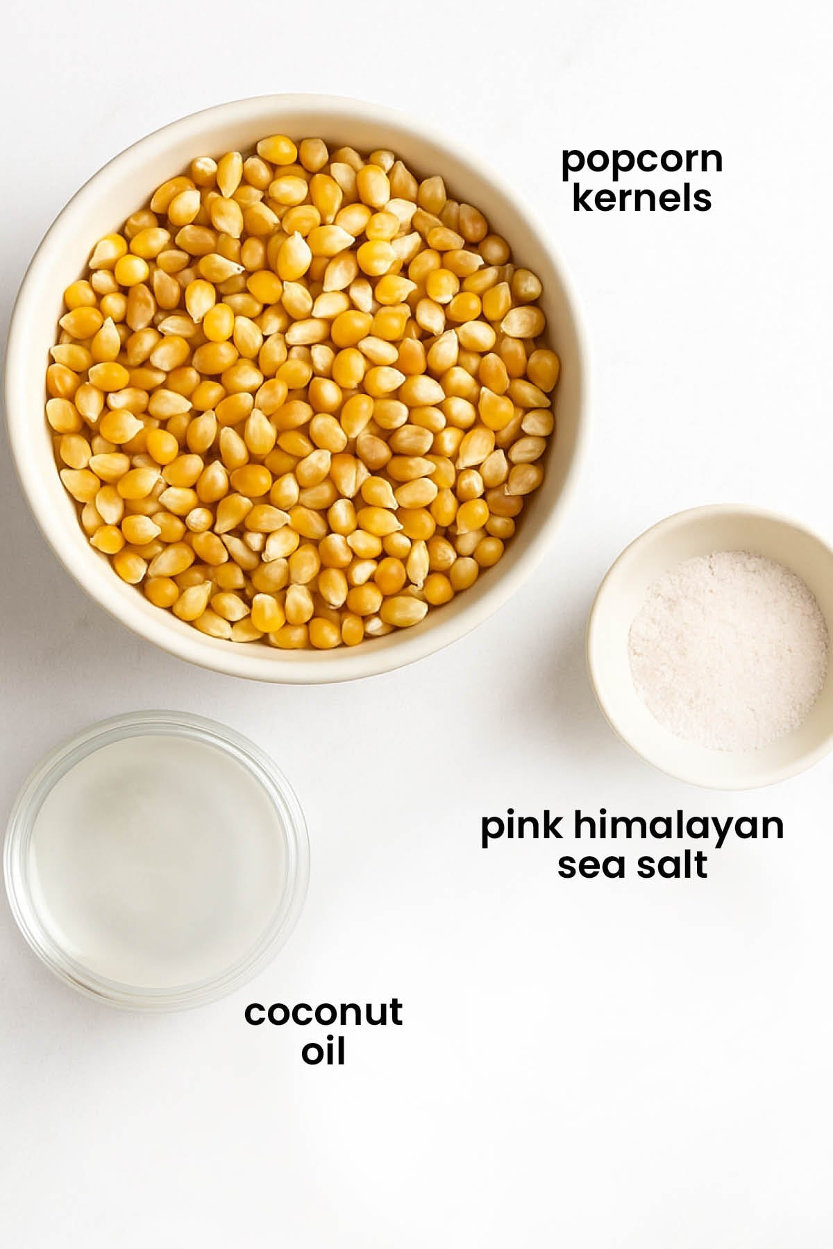 individual ingredients for pink Himalayan sea salt popcorn laid out against a white background.