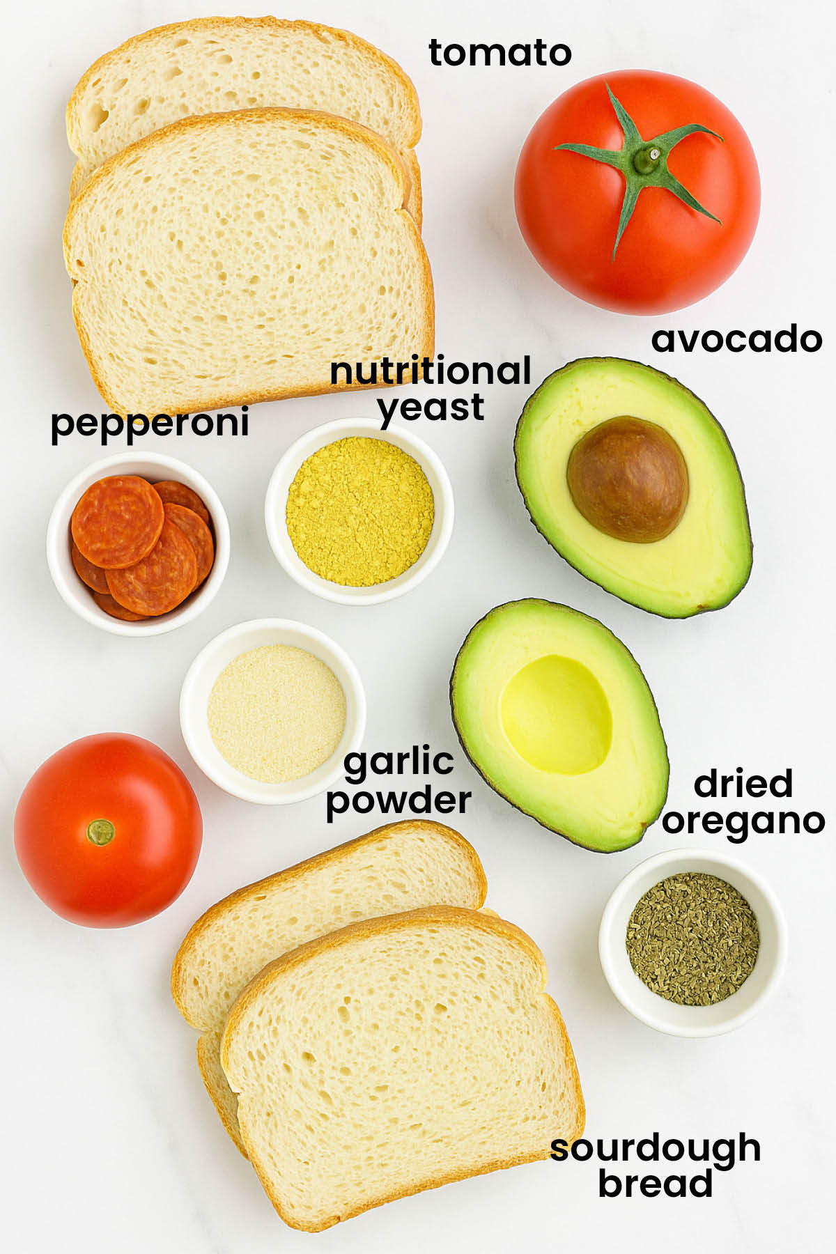 individual ingredients for pizza avocado toast laid out against a white background.