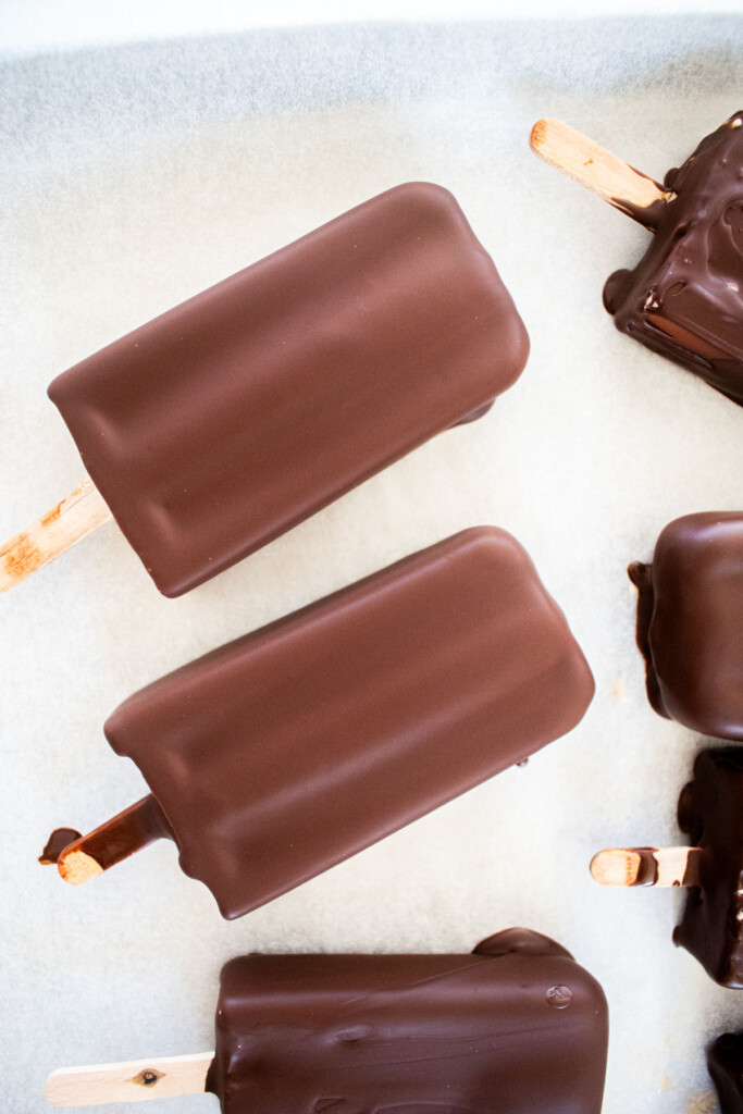 vegan chocolate peanut butter ice cream bars on parchment paper.