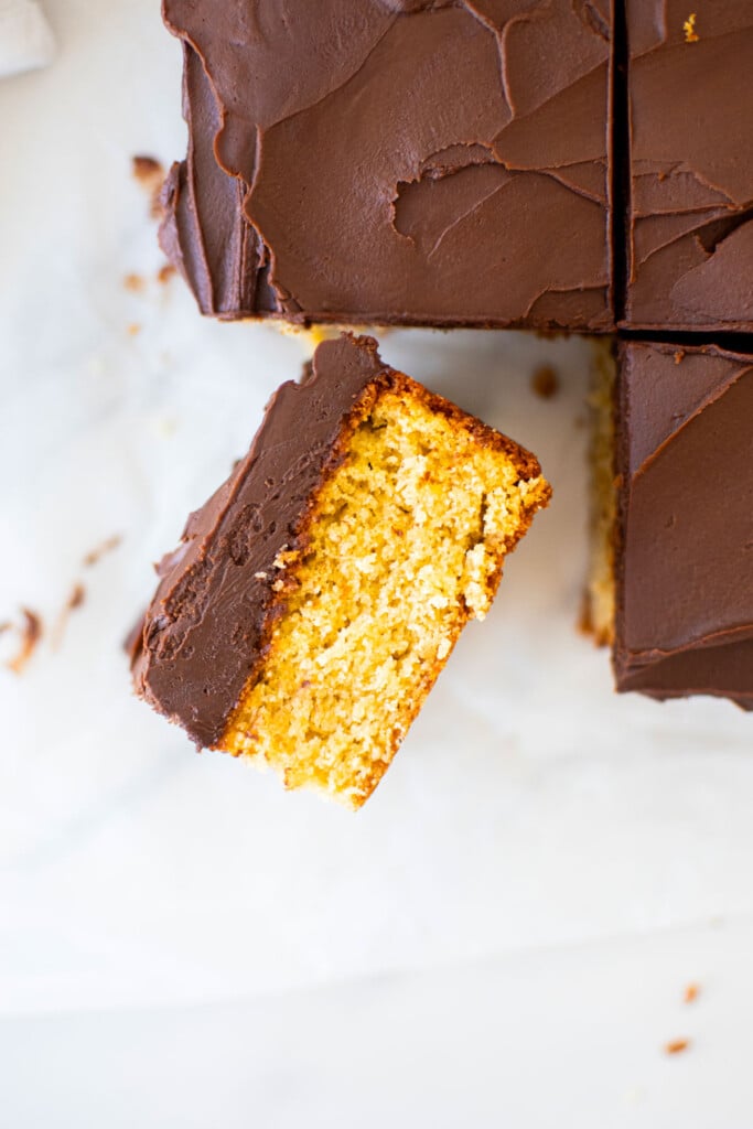 chocolate peanut butter banana cake cut into square slices on a white marble table.