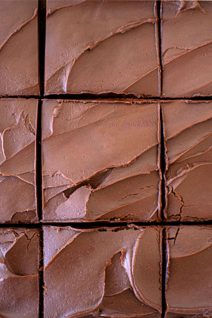 chocolate peanut butter banana cake cut into square slices.