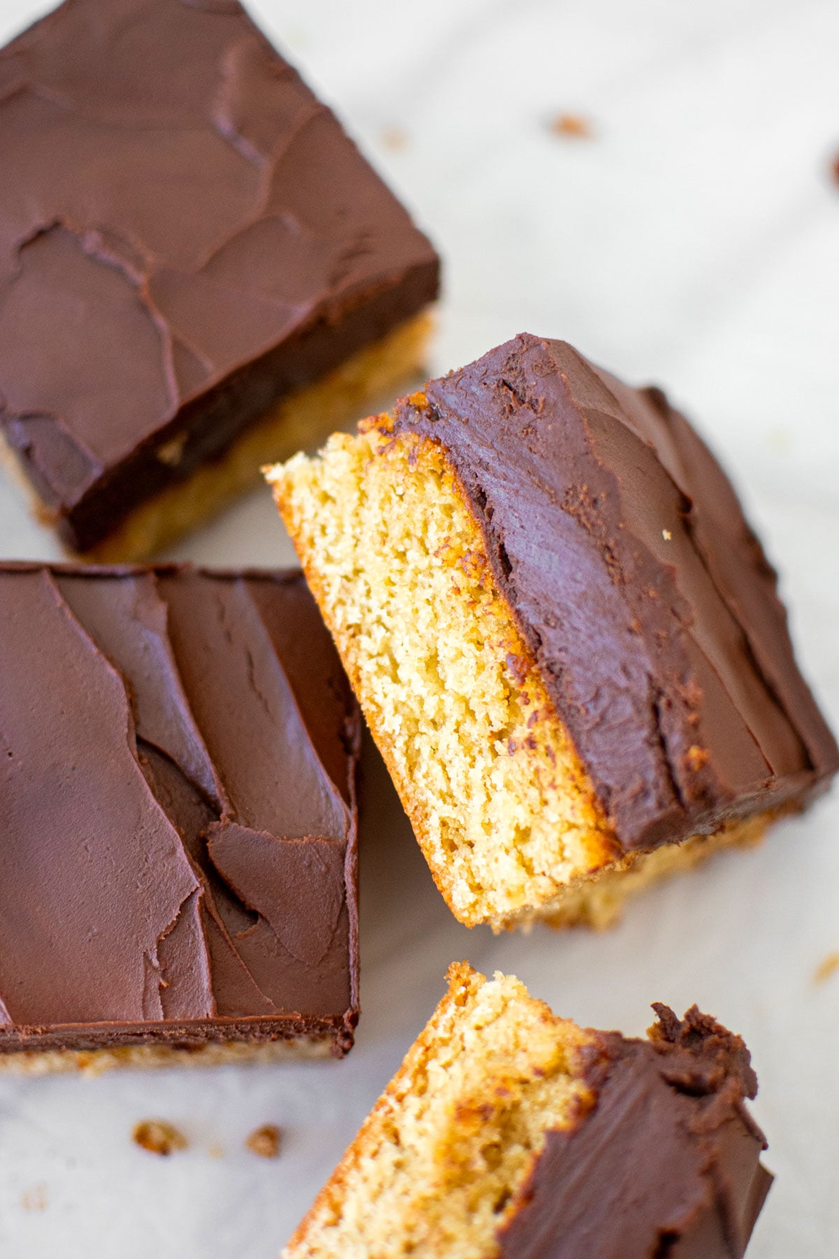 chocolate peanut butter banana cake cut into square slices on a white marble table.