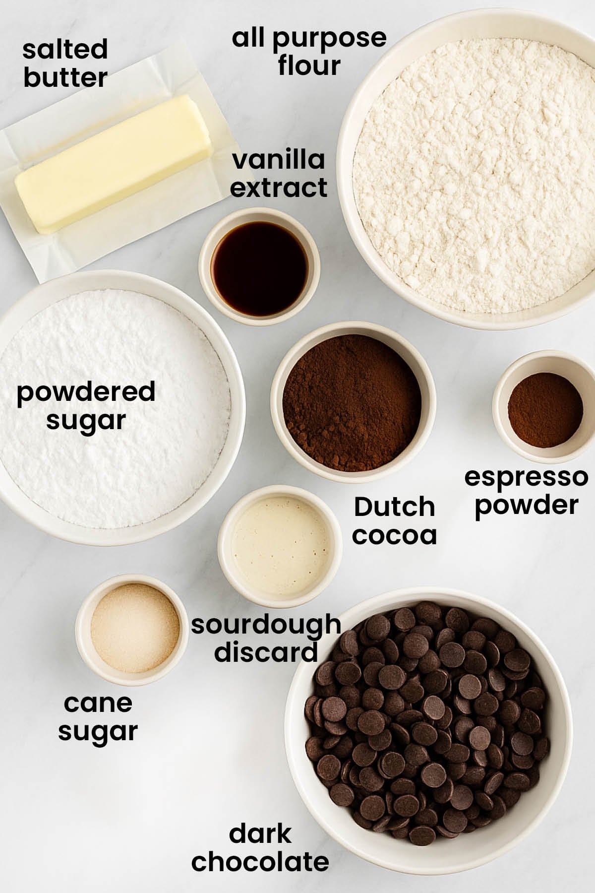 individual ingredients for sourdough chocolate shortbread cookies laid out against a white background.