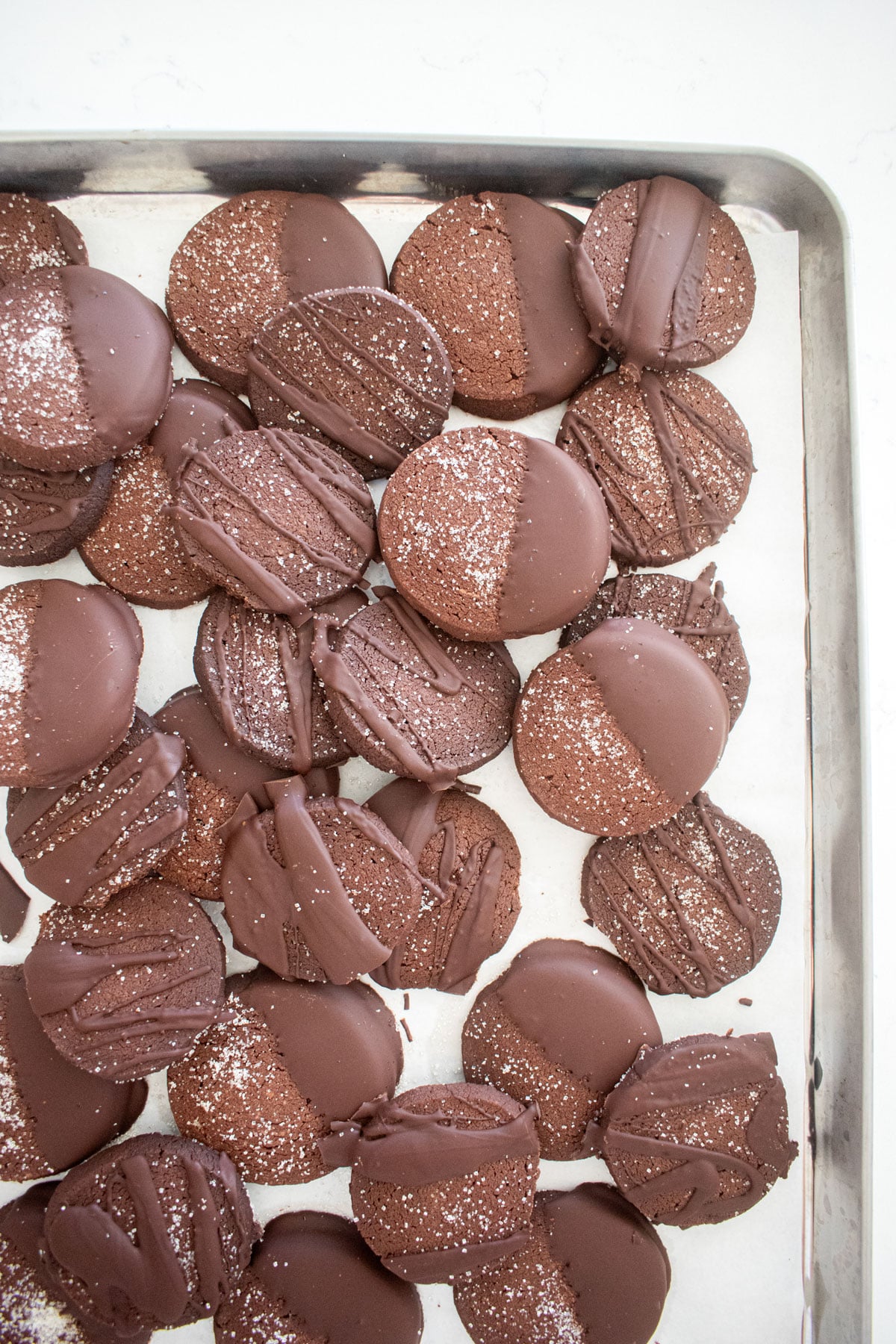 sourdough chocolate shortbread cookies with chocolate on a baking sheet.