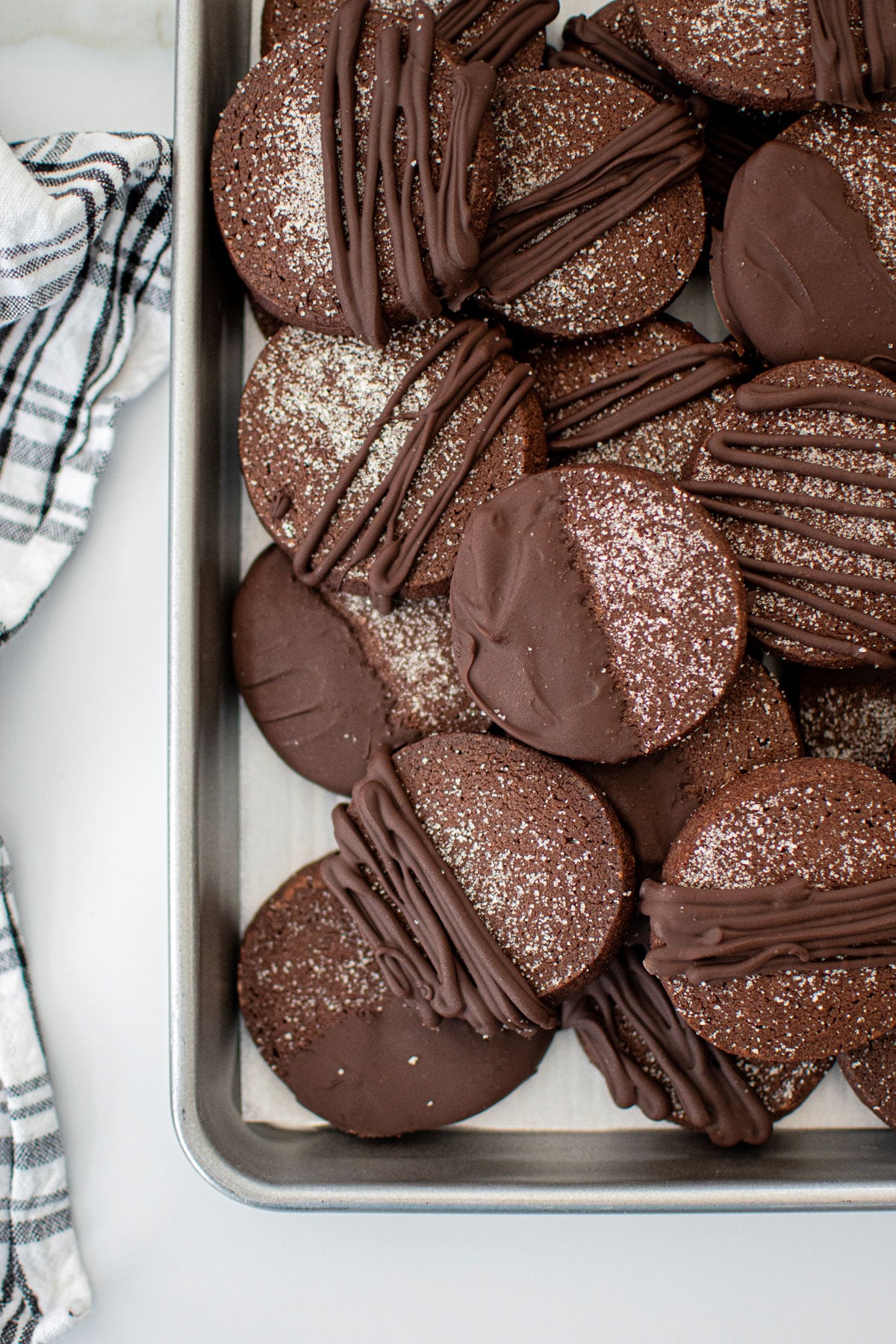 baking sheet of sourdough chocolate shortbread cookies on a marble counter.