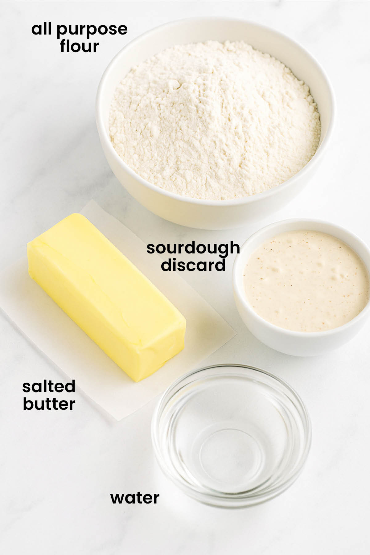 individual ingredients for sourdough discard pie crust laid out against a white background.