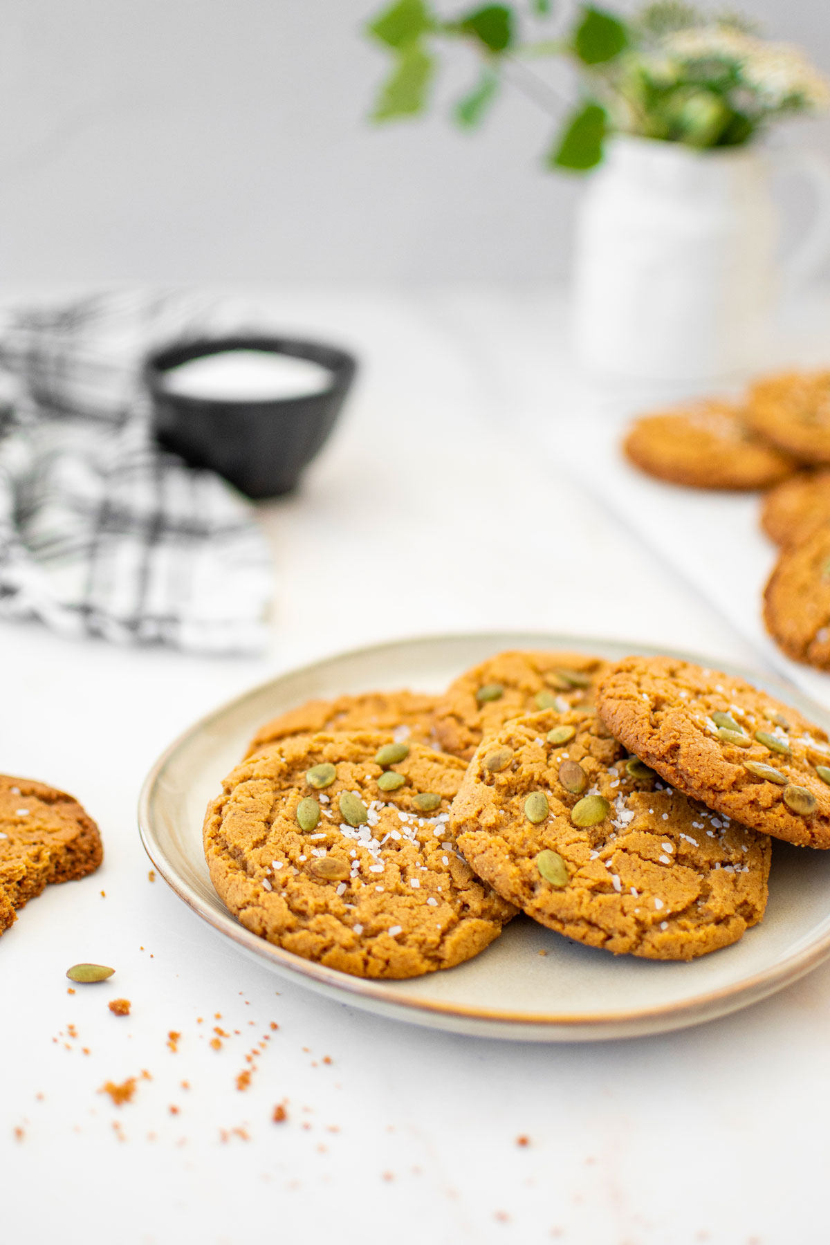 vegan pumpkin spice almond butter cookies on a plate on a marble countertop.