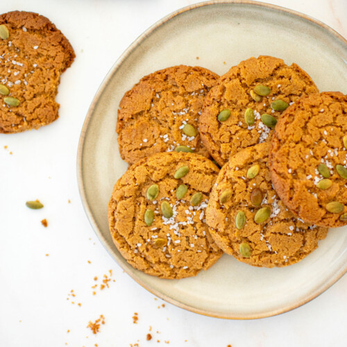 vegan pumpkin spice almond butter cookies on a plate on a marble countertop.