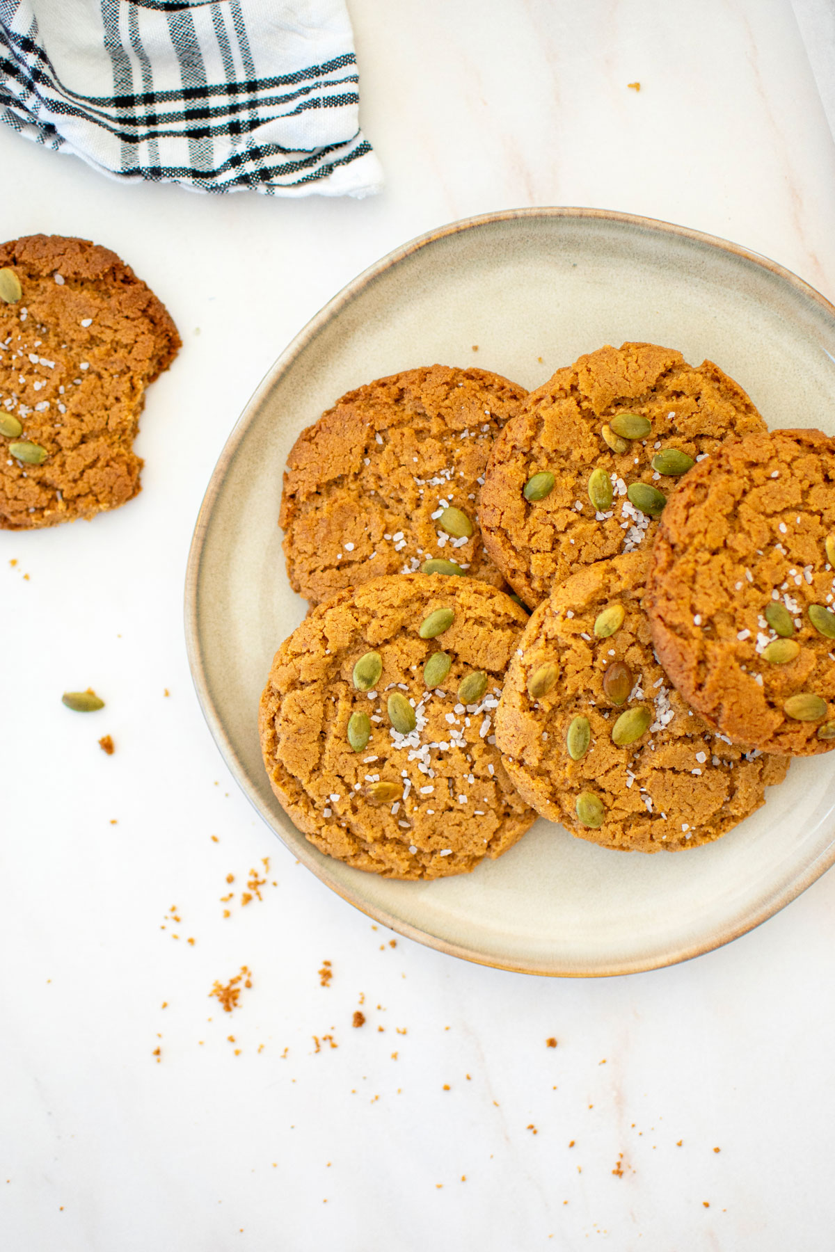 vegan pumpkin spice almond butter cookies on a plate on a marble countertop.