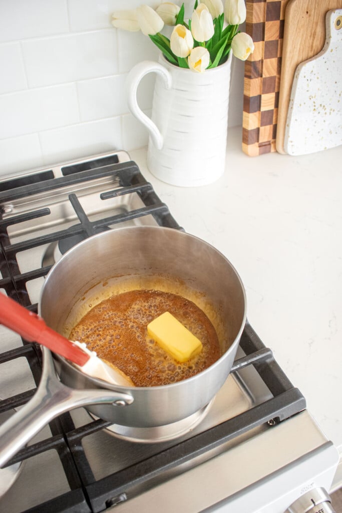 caramel being made in a stainless steel pot on the stoveop.