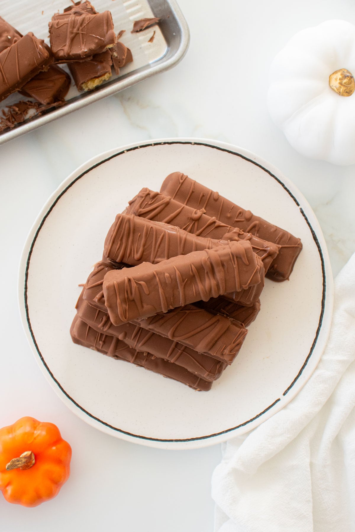 homemade twix bars on a plate on a marble counter.