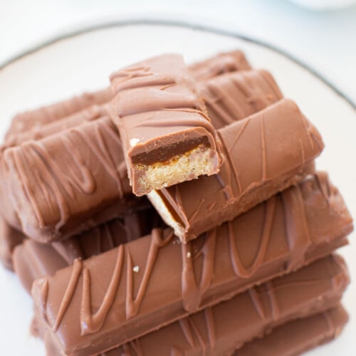 homemade twix bars on a plate on a marble counter.
