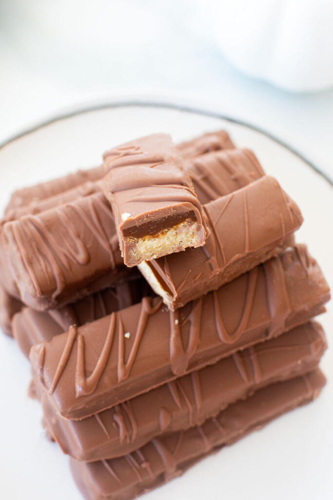 homemade twix bars on a plate on a marble counter.
