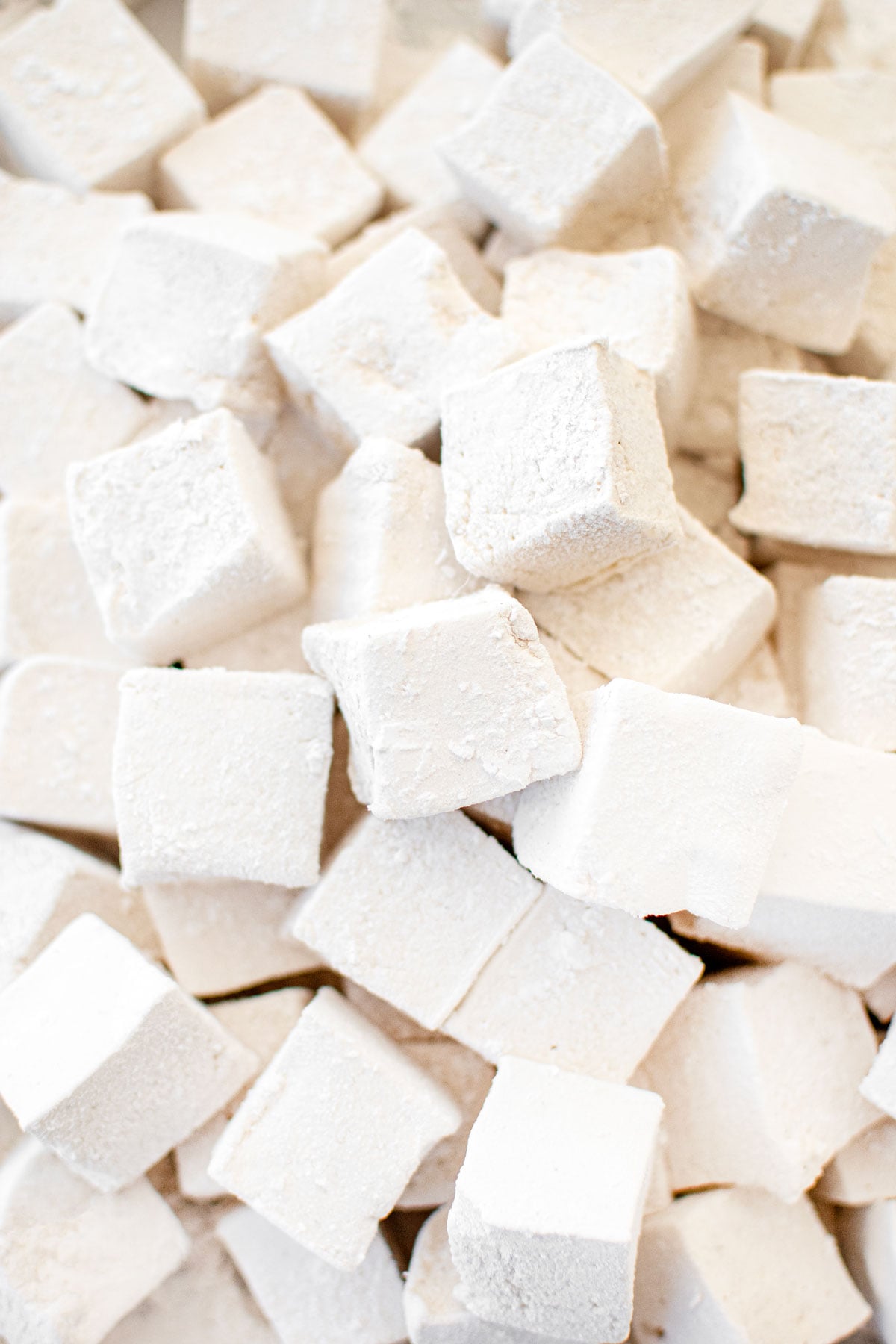 homemade mini marshmallows on a baking sheet.
