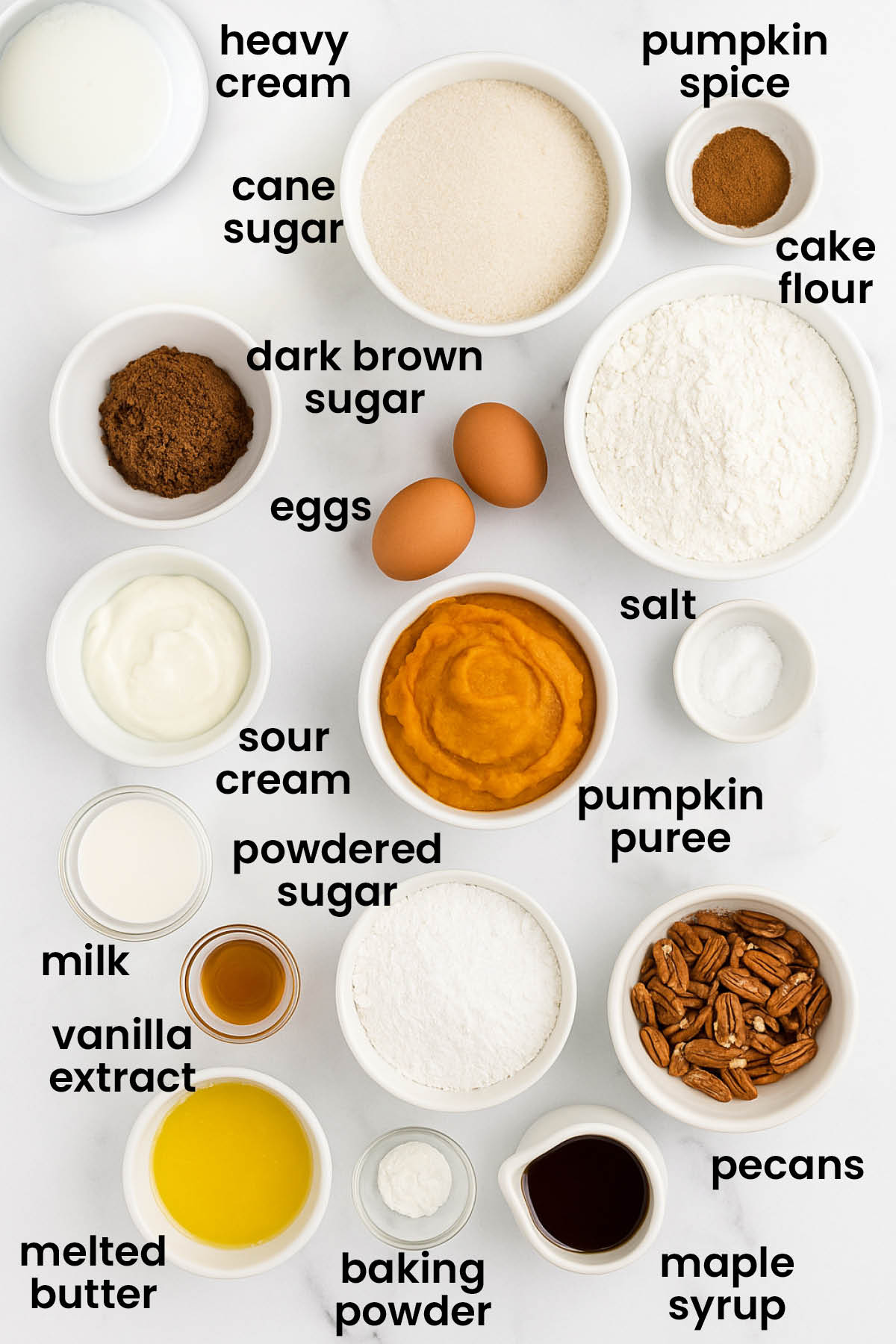 individual ingredients for maple pumpkin spice baked donuts laid out against a white background.
