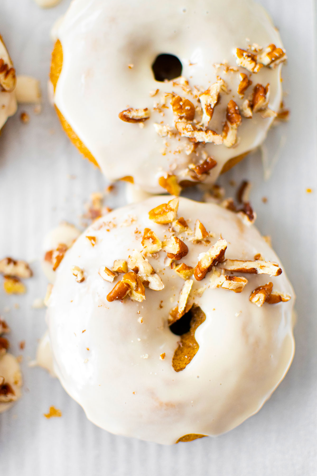 maple pumpkin spice baked donuts on a baking sheet.