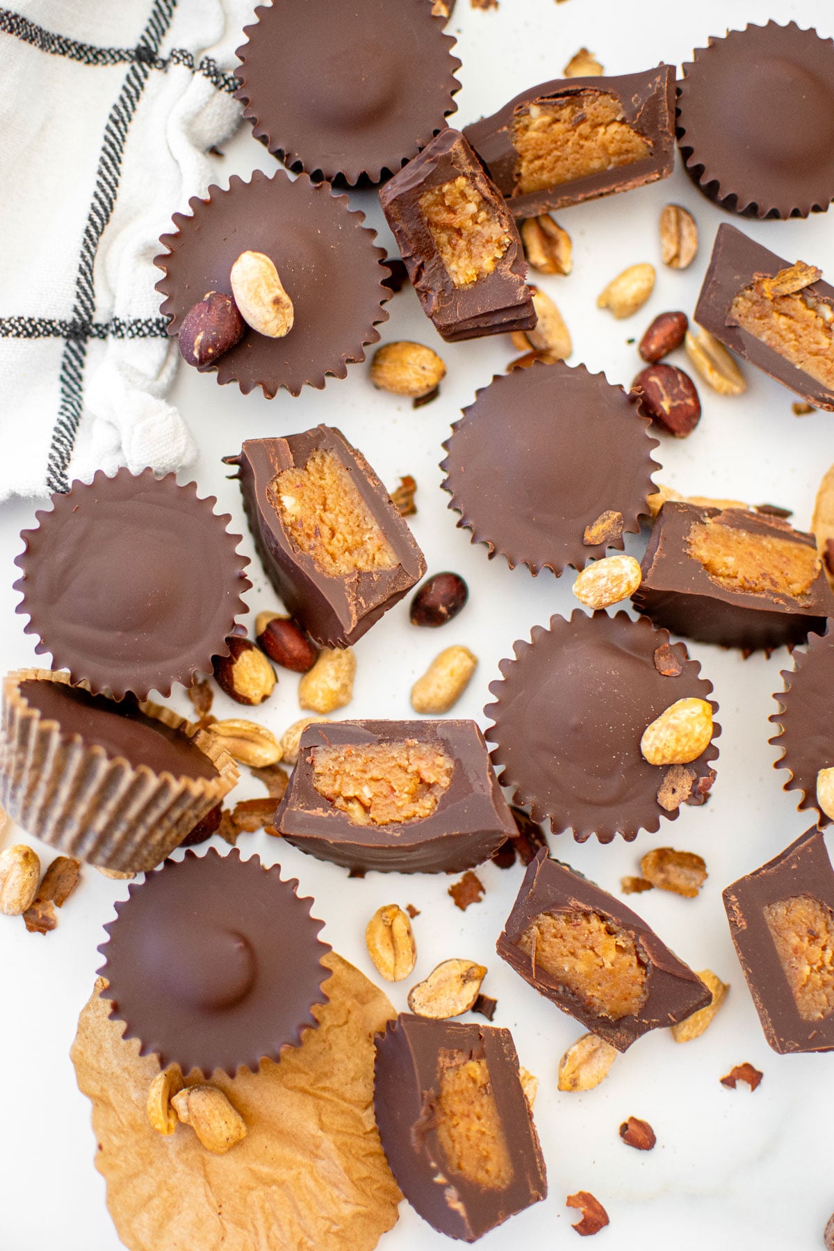 vegan dark chocolate mini peanut butter cups on a white marble counter.