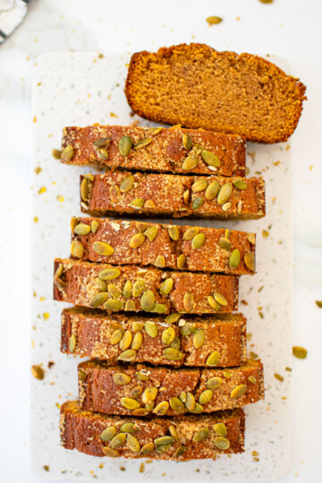 sliced cinnamon sweet potato bread without eggs on a a white marble board.