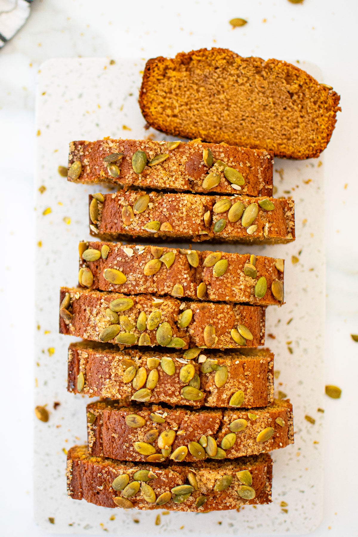 sliced cinnamon sweet potato bread without eggs on a a white marble board.