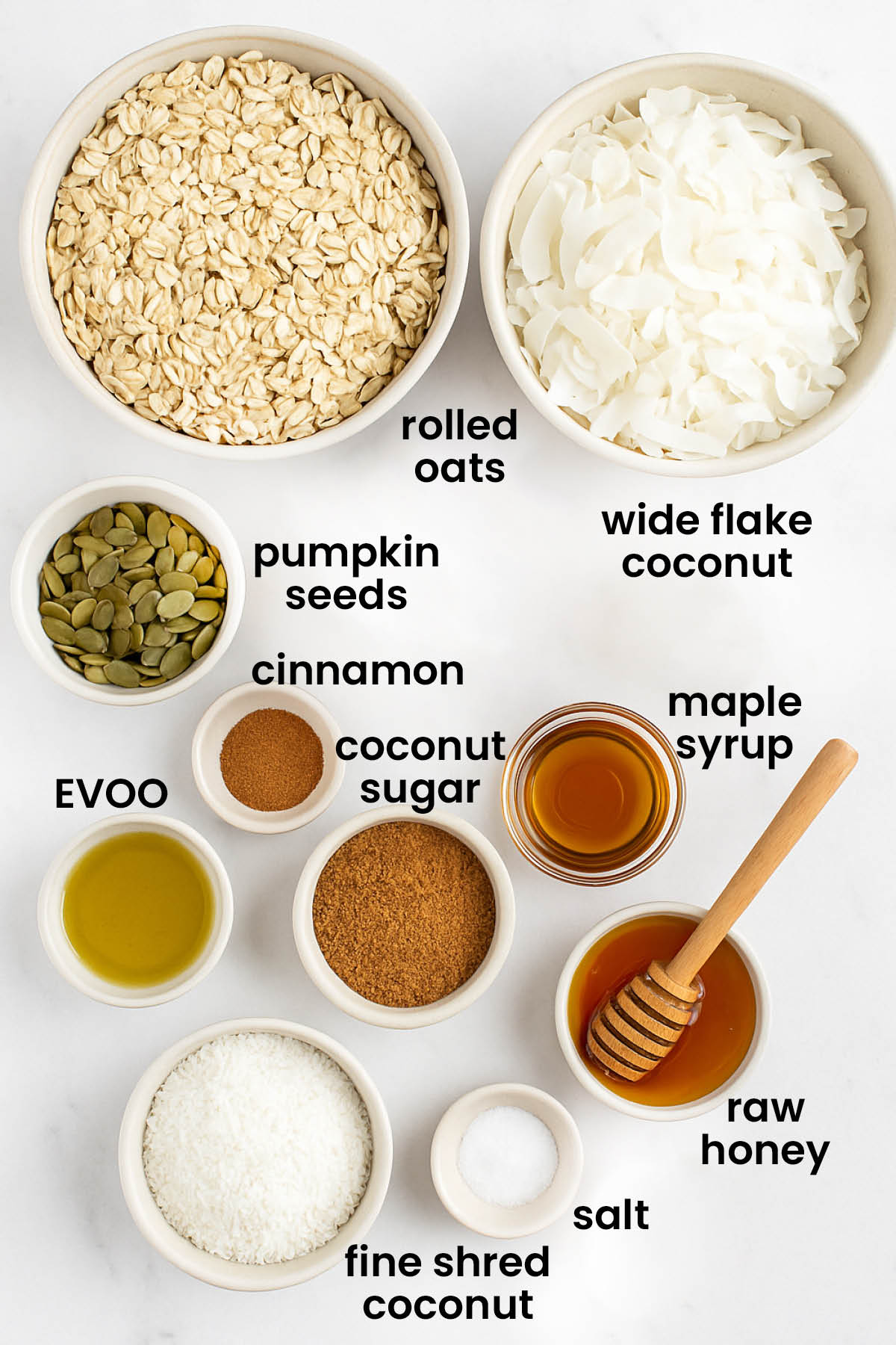 individual ingredients for maple cinnamon olive oil granola laid out against a white background.