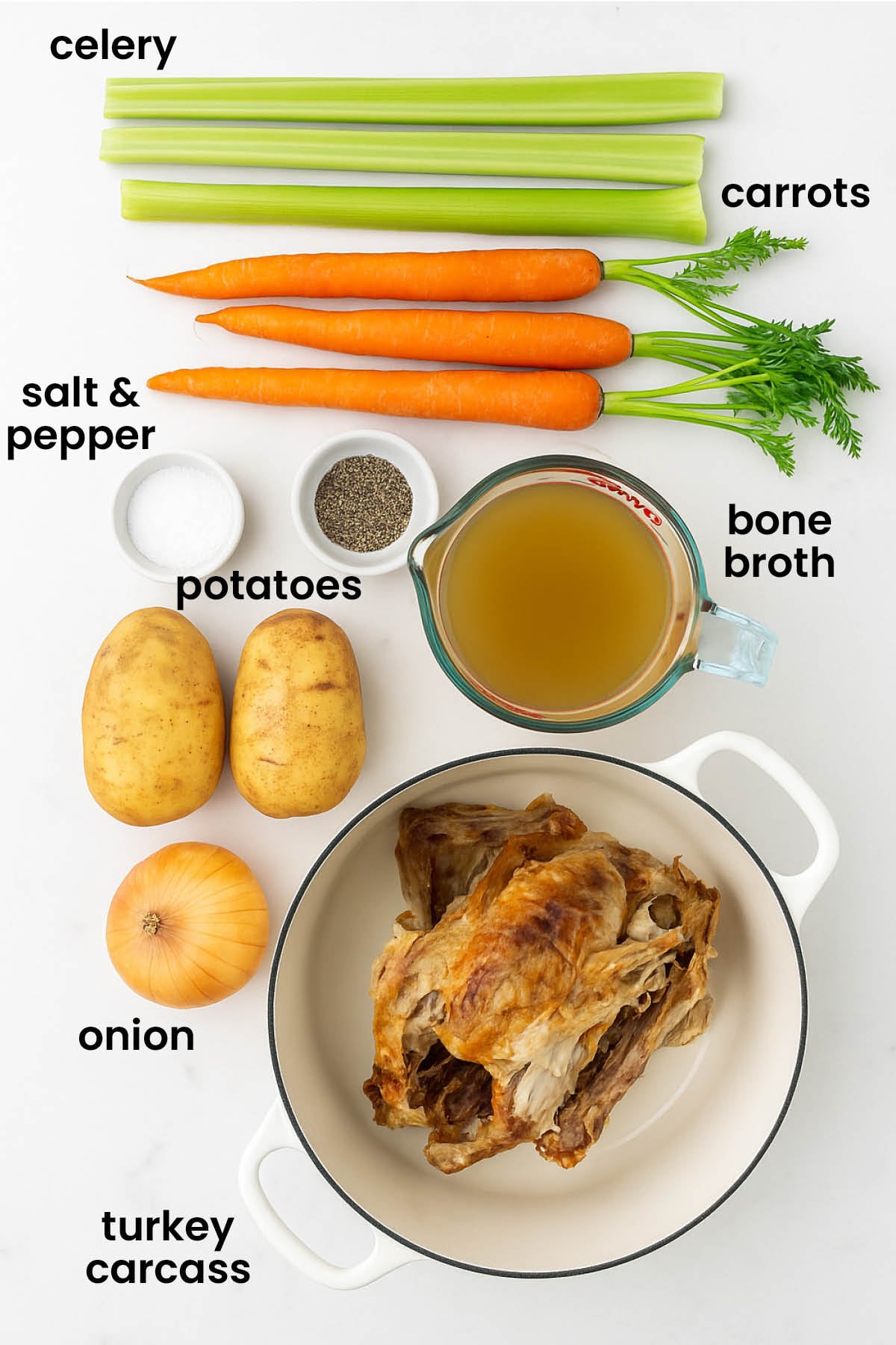individual ingredients for turkey carcass soup laid out against a white background.