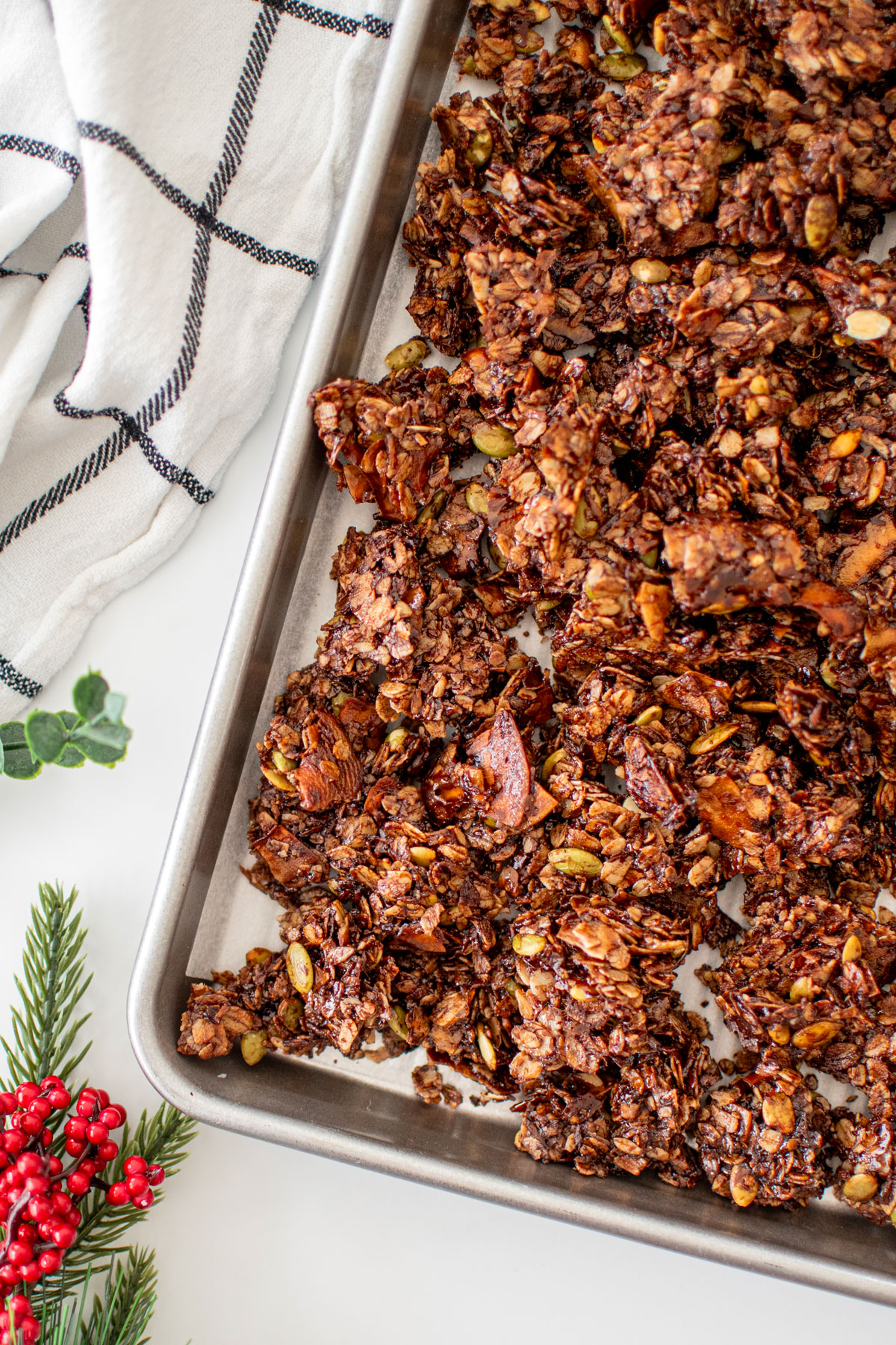 baking sheet of chocolate peppermint olive oil granola on a white marble counter.